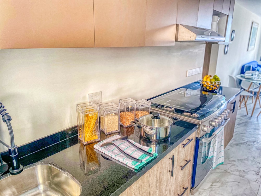 a kitchen with a sink, stove and counter top