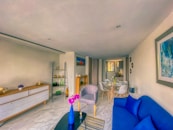 a living room filled with furniture and a blue couch