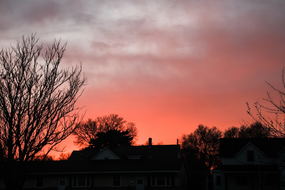 a red sky is seen over a neighborhood