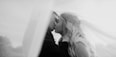 a bride and groom kissing in a black and white photo