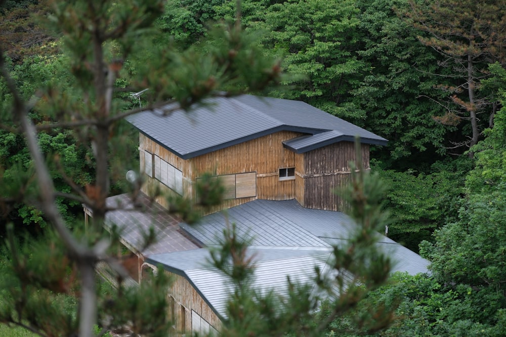 a house in the middle of a forest surrounded by trees