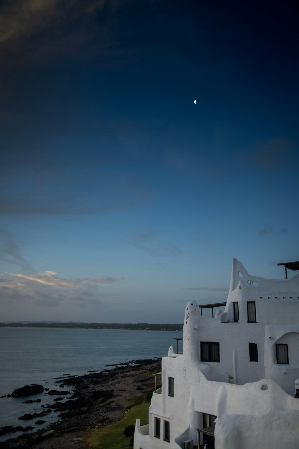 a white building with a moon in the sky