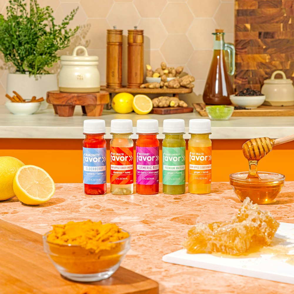 a wooden table topped with jars of honey and lemons