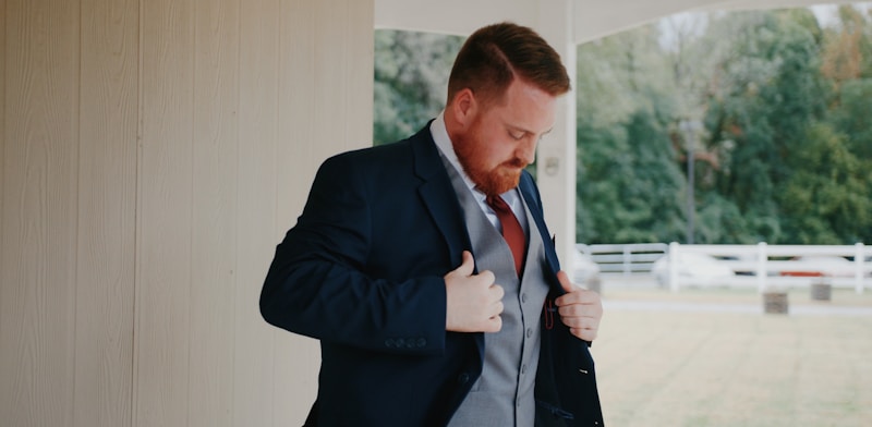 a man in a suit and tie standing in a room