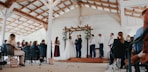a group of people standing around a wooden structure