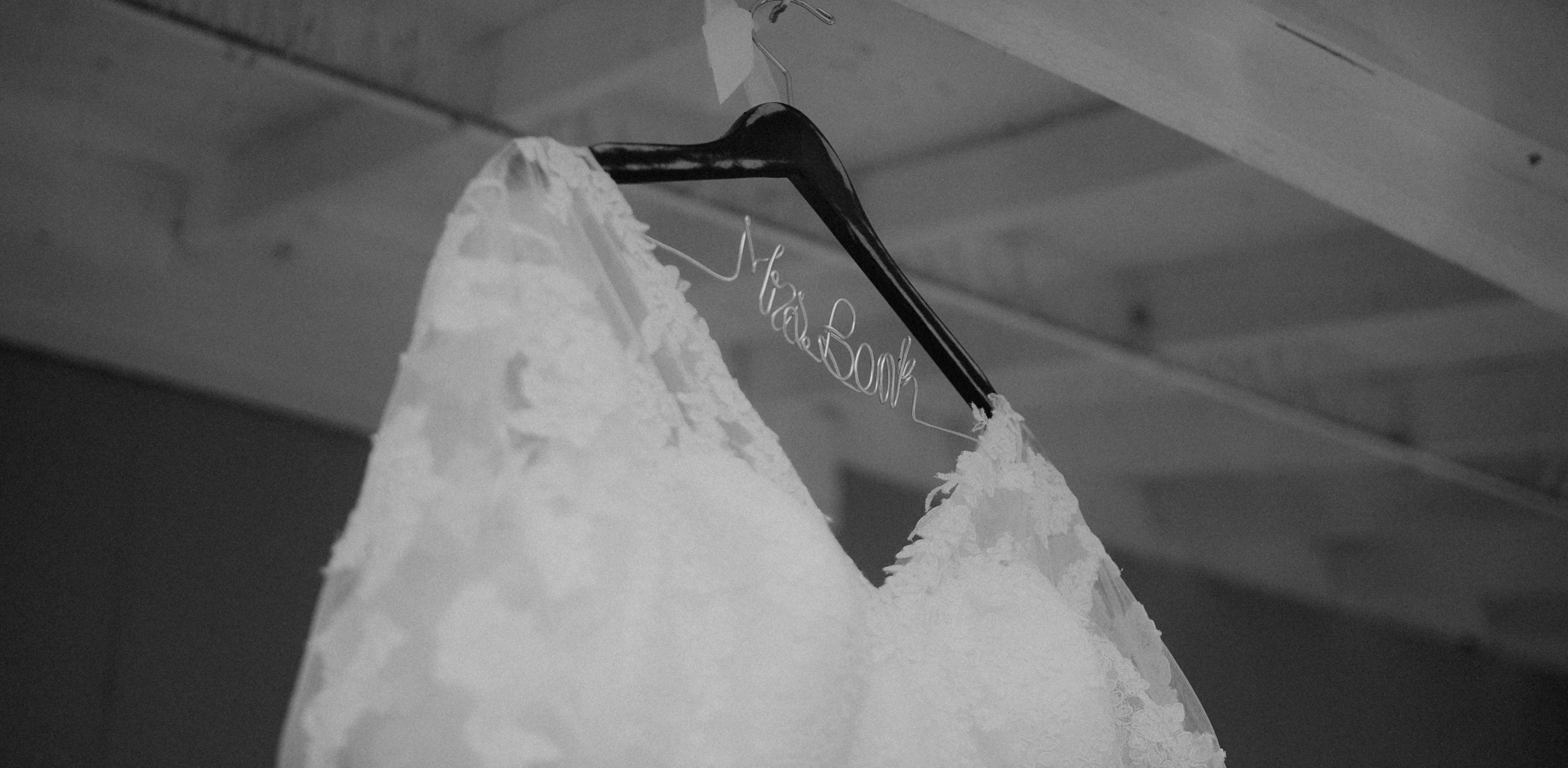 a wedding dress hanging from a hanger
