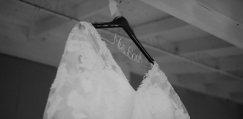 a wedding dress hanging from a hanger