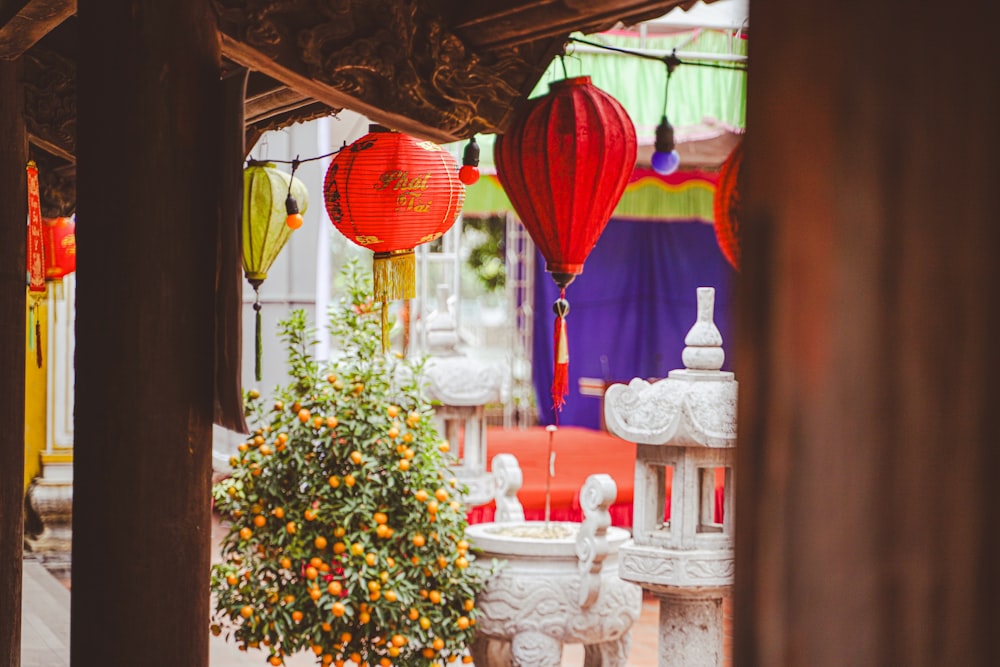 a group of lanterns hanging from the ceiling of a building