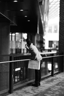 a person standing on a sidewalk with a bag