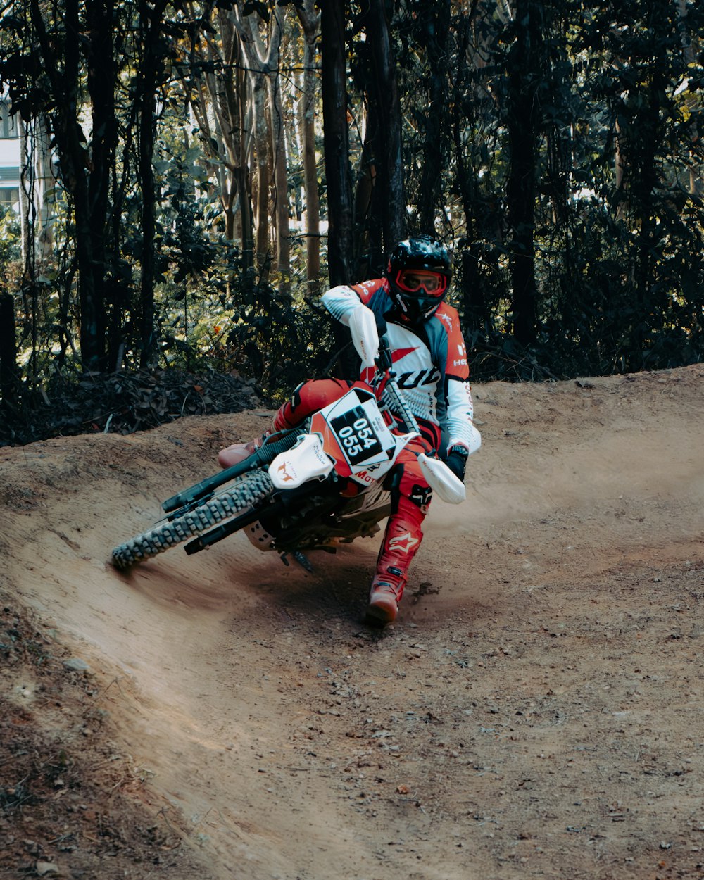 a man riding a dirt bike on top of a dirt field