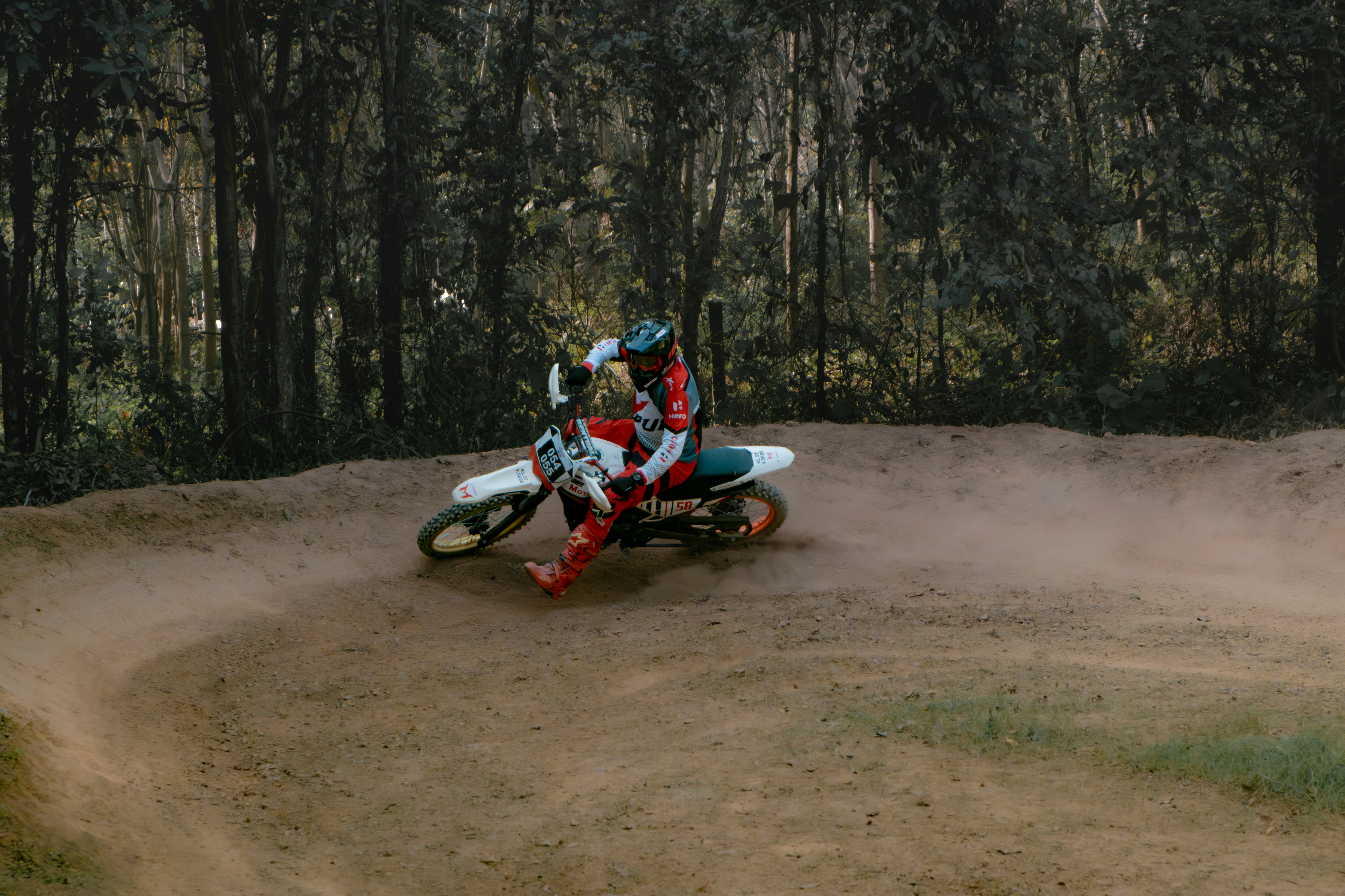 a person riding a dirt bike on a dirt track