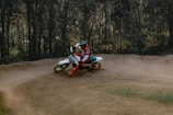 a person riding a dirt bike on a dirt track
