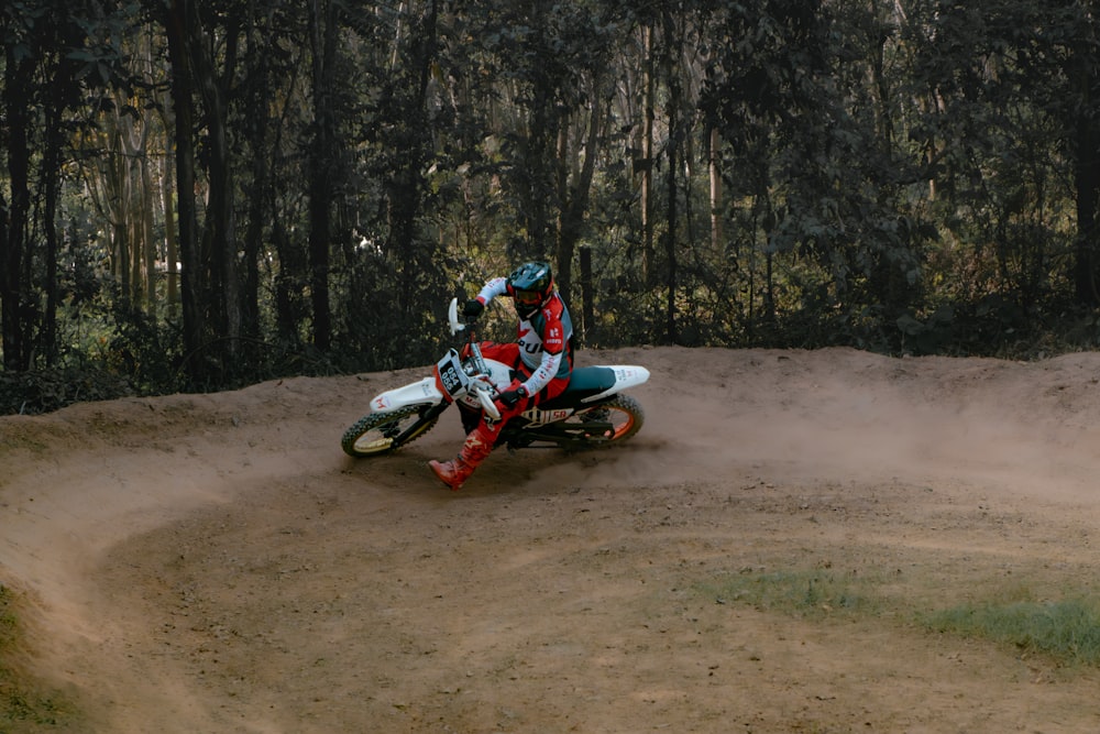 a person riding a dirt bike on a dirt track