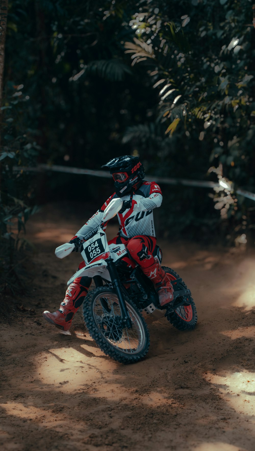 a person riding a dirt bike on a dirt road