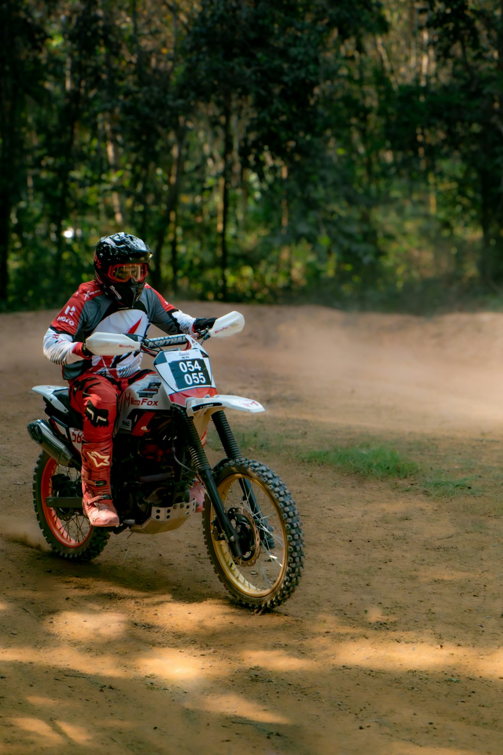 a person riding a dirt bike on a dirt road