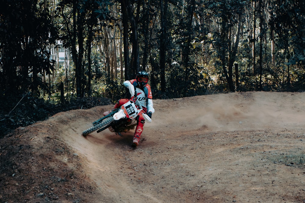 a man riding a dirt bike on top of a dirt field