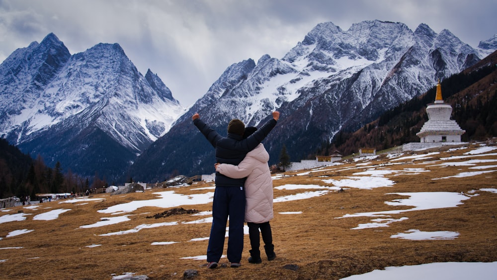 a couple of people that are standing in the snow