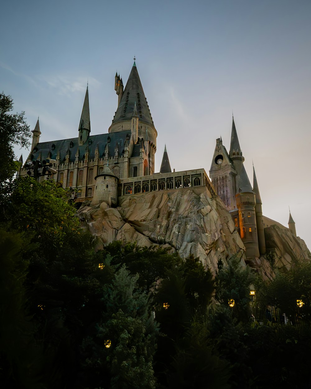 a castle on top of a mountain with a sky background