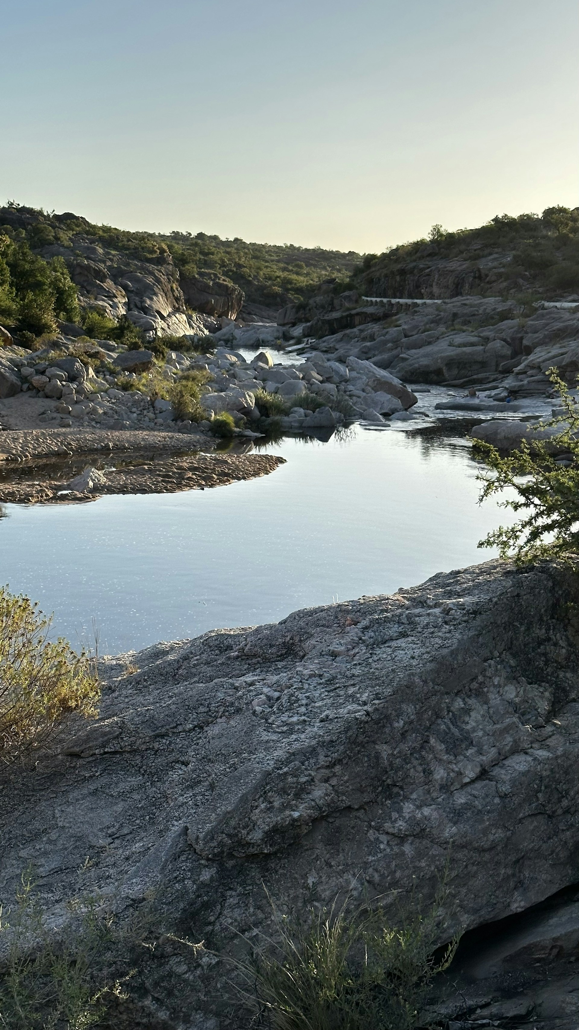 a large body of water surrounded by rocky terrain