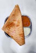 a plate with a pita and sauces on it