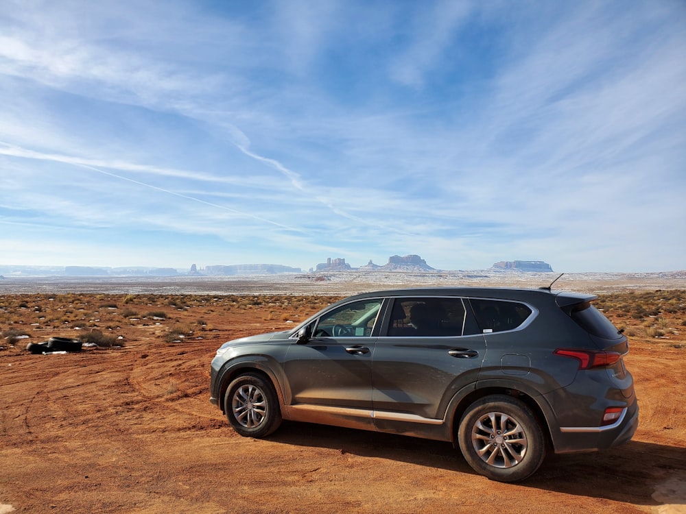 a car parked on a dirt road in the desert