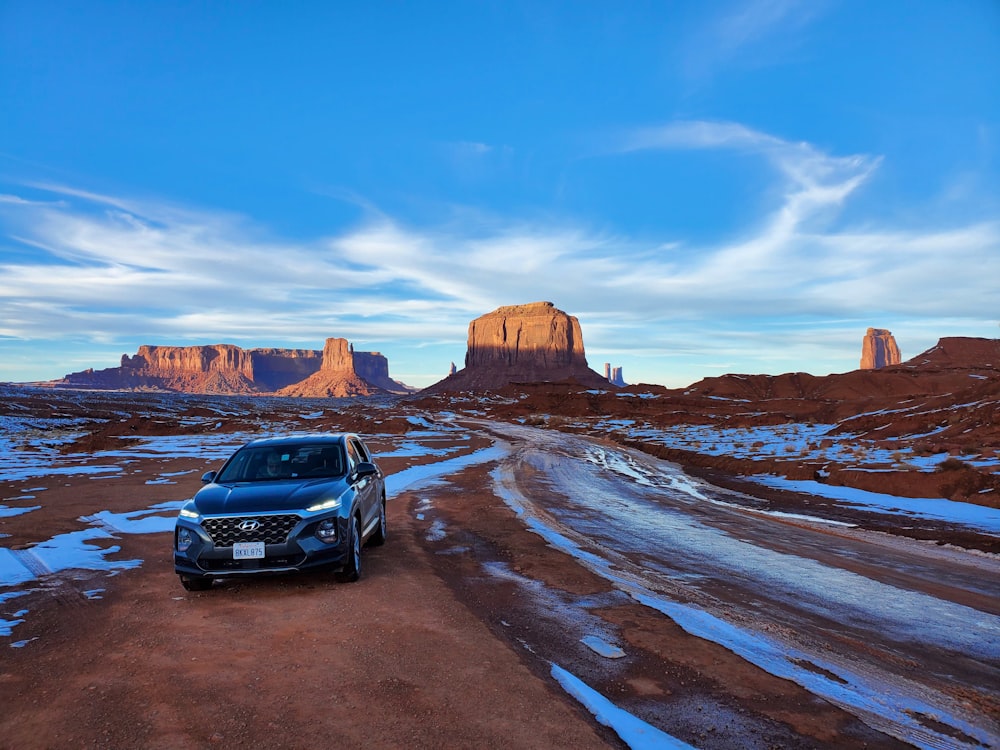 a car parked on the side of a dirt road