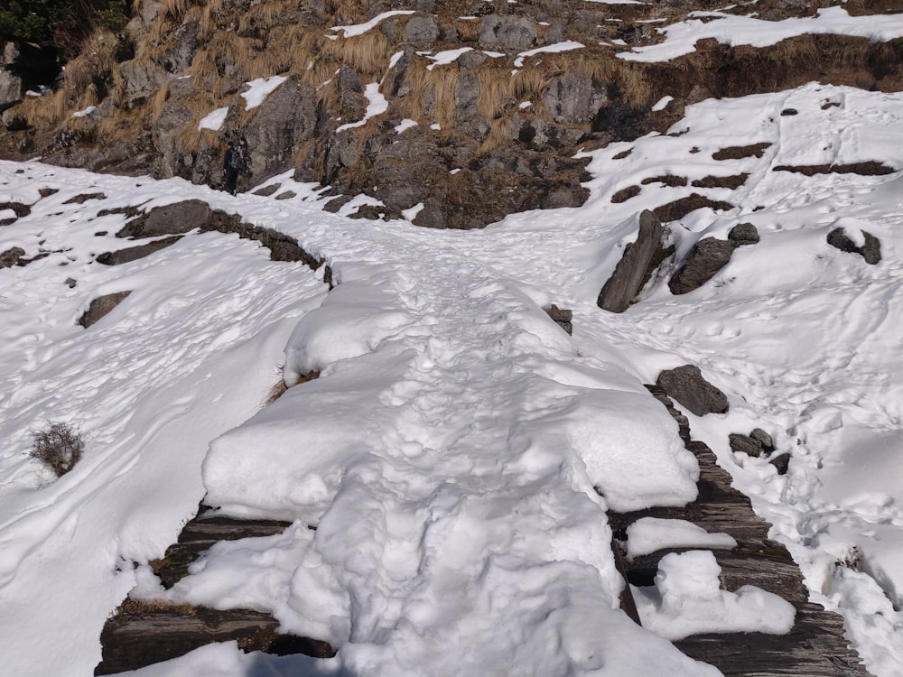 a snow covered path leading to a cliff