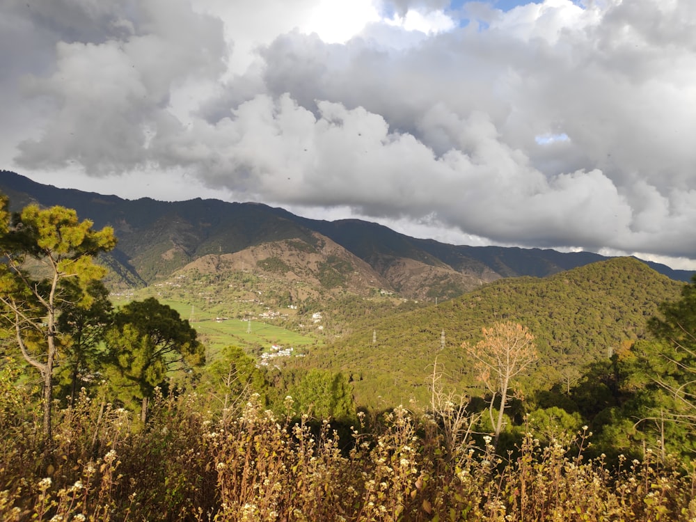 a view of a mountain range with clouds in the sky