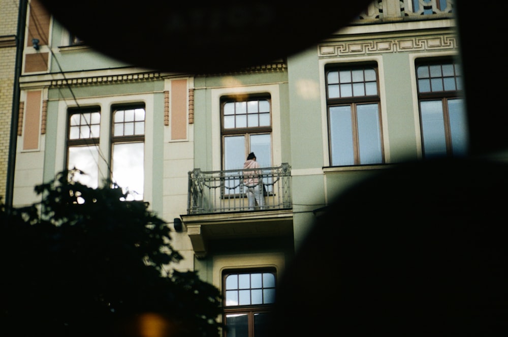 a person standing on a balcony of a building