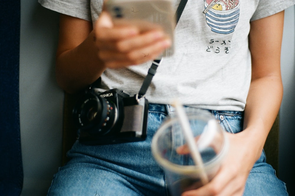 a woman holding a camera and taking a picture