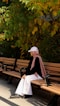a woman sitting on a bench in a park