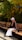 a woman sitting on a bench in a park
