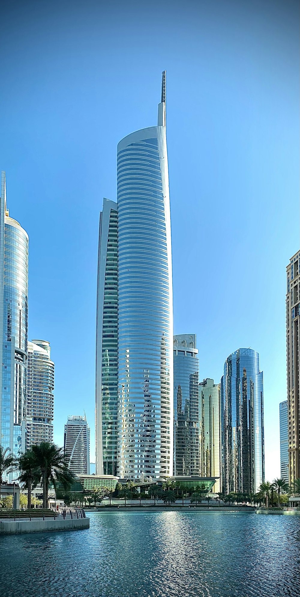 a body of water in front of tall buildings