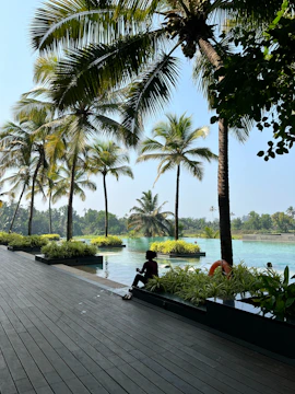 a person sitting on a bench near a body of water