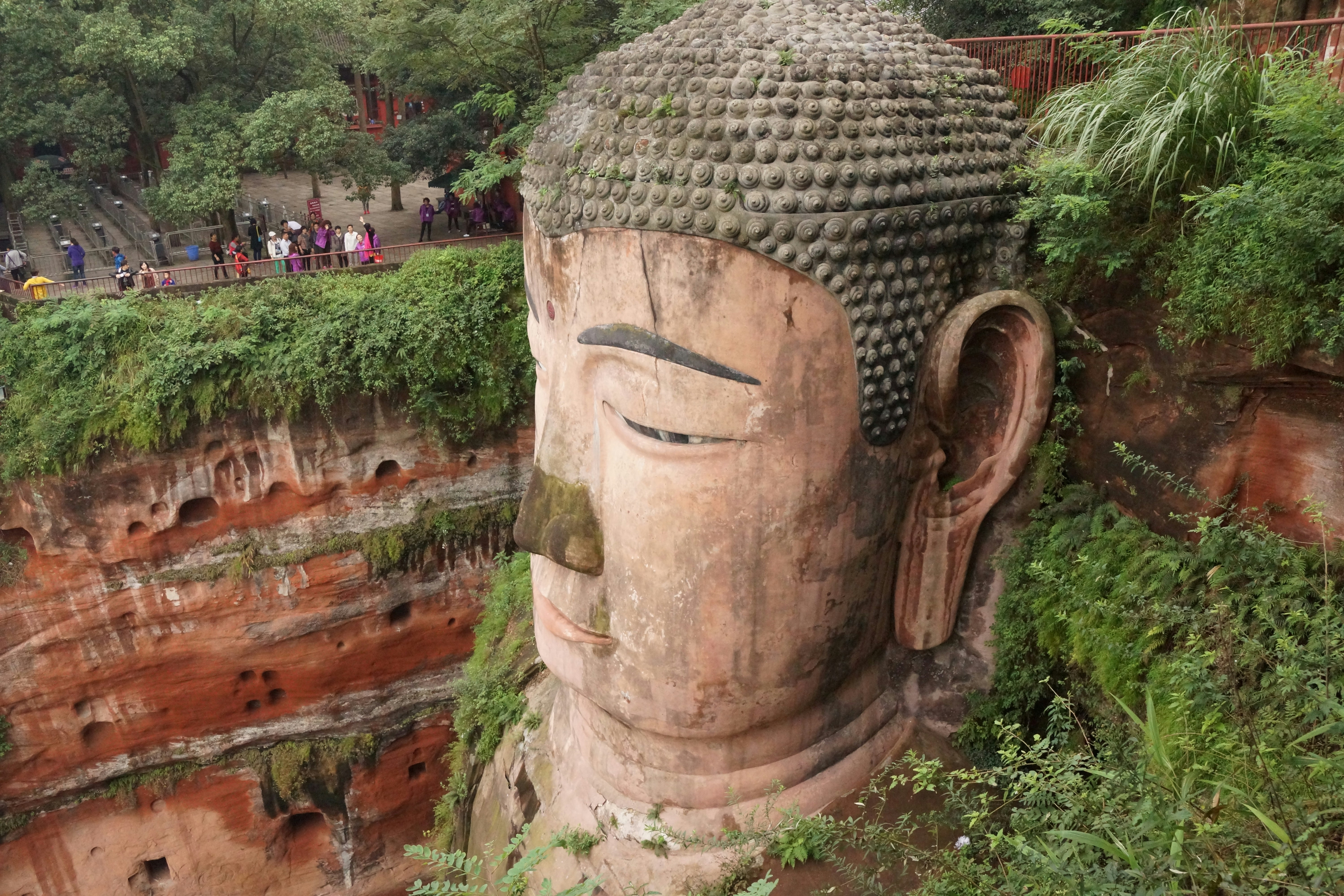 Athugala Rock Kurunegala Sri Lanka, massive rocky outcrop with Buddha statue, surrounded by town and green landscape
