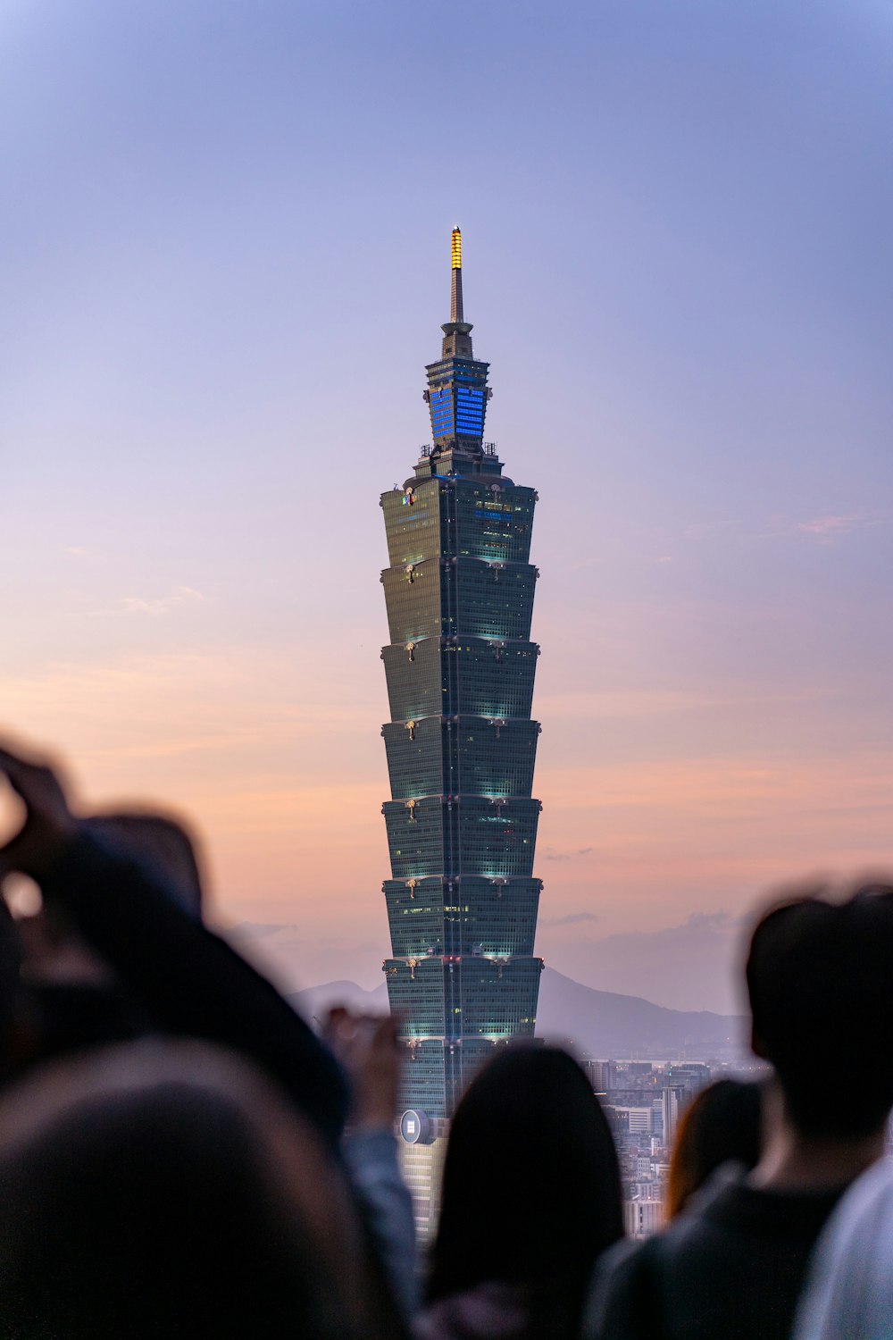 a group of people standing in front of a tall building