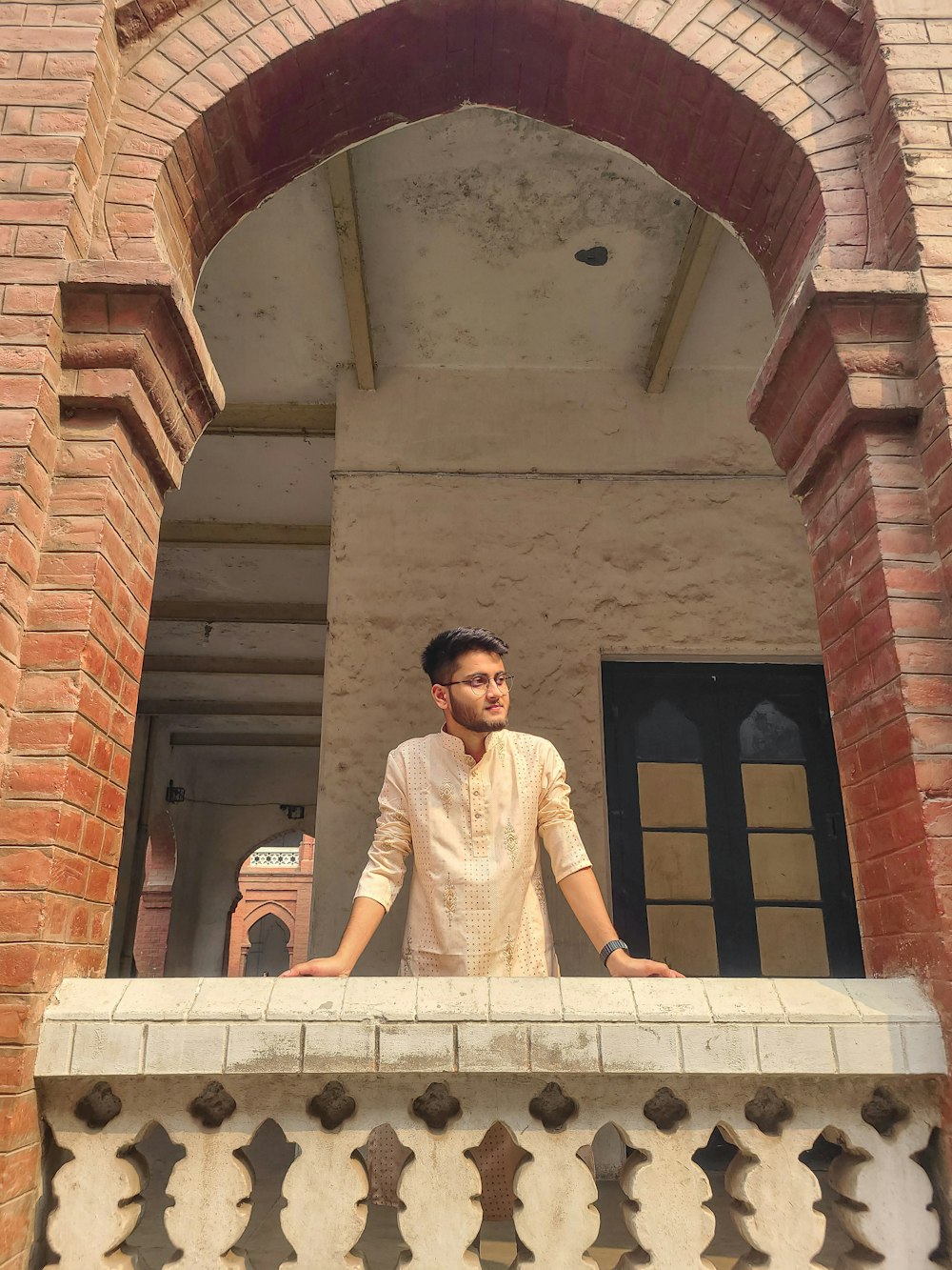 a man standing on the balcony of a building