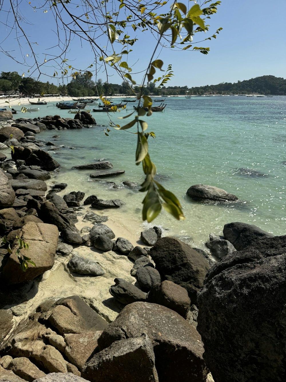 a view of a beach with rocks and water