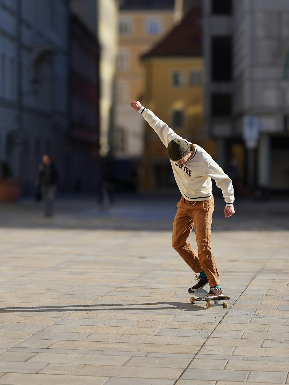 a man riding a skateboard down a sidewalk