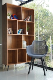 a chair and a book shelf in a room