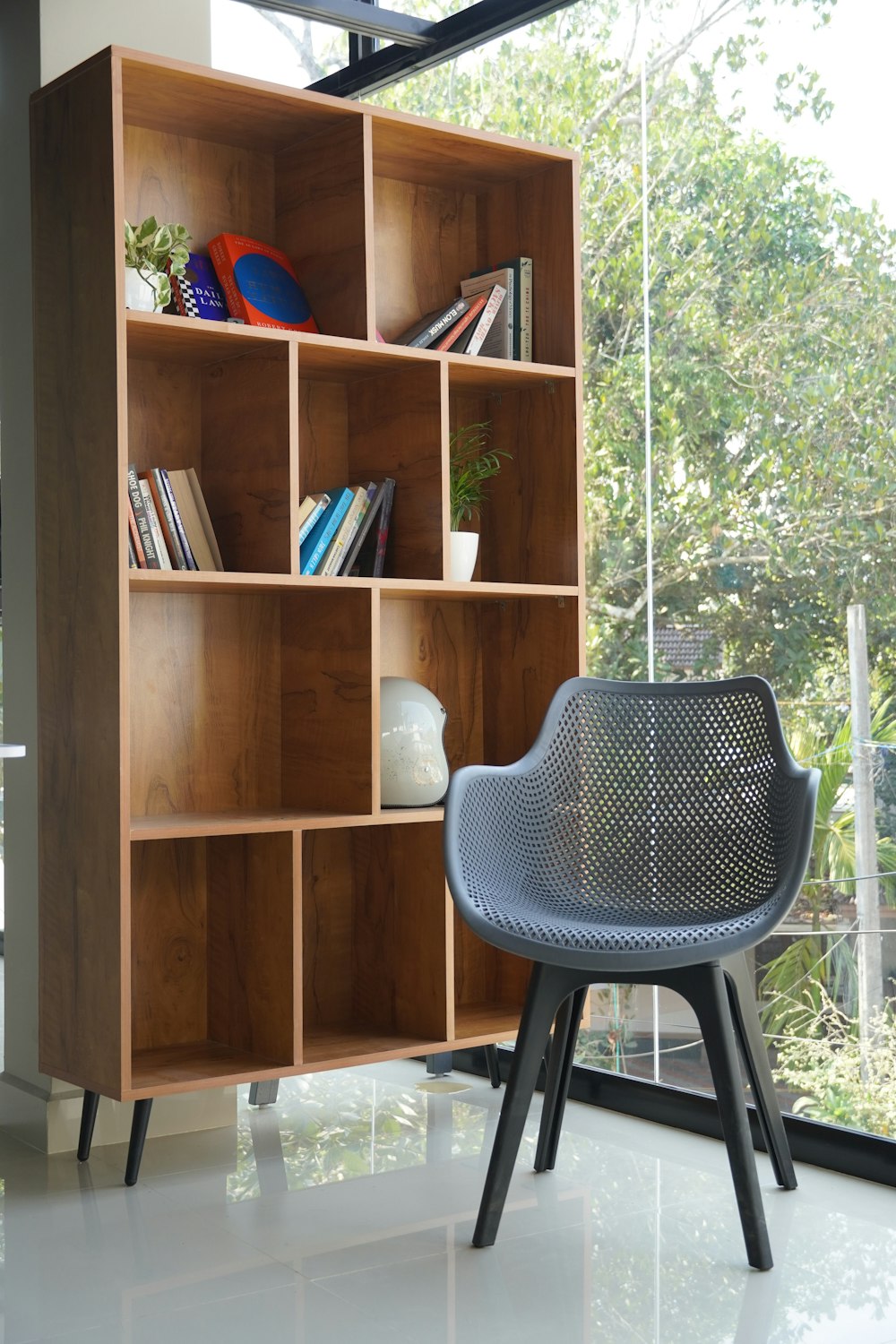 a chair and a book shelf in a room