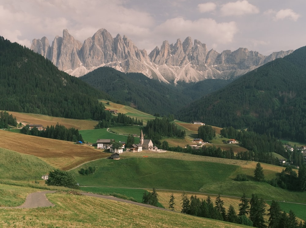 a scenic view of a mountain range with a church in the foreground