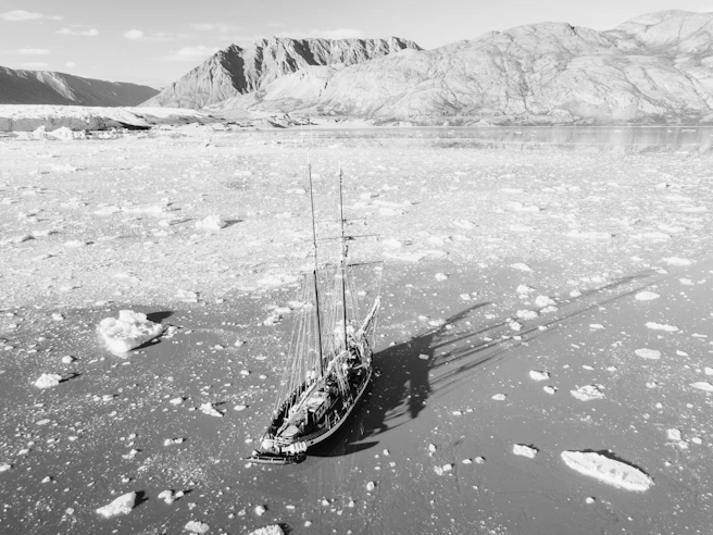 a boat floating on top of an ice covered lake