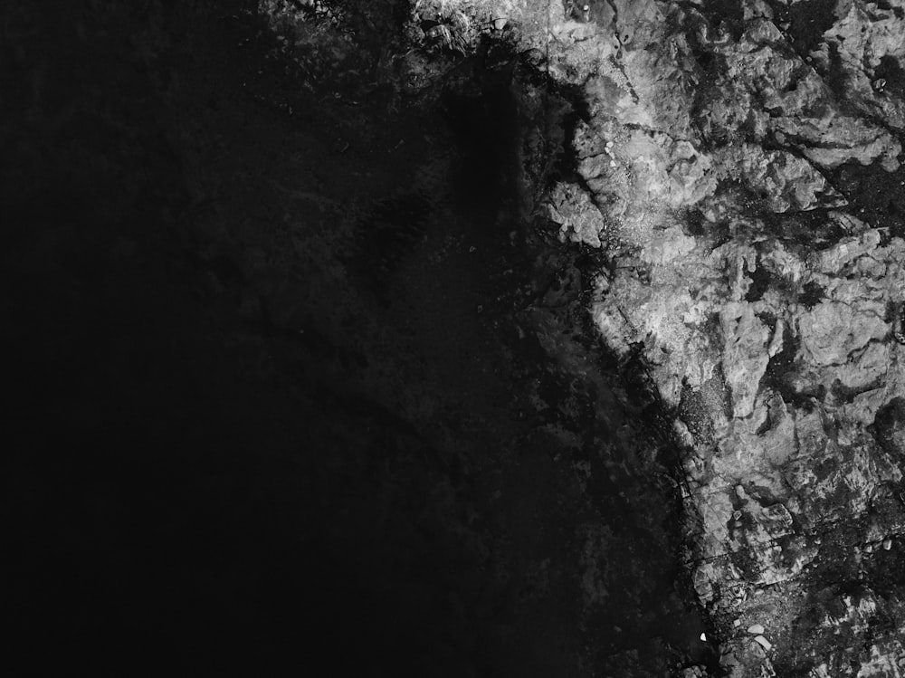 a black and white photo of a rock formation