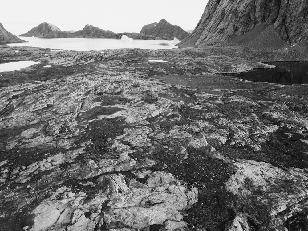 a black and white photo of some rocks and water