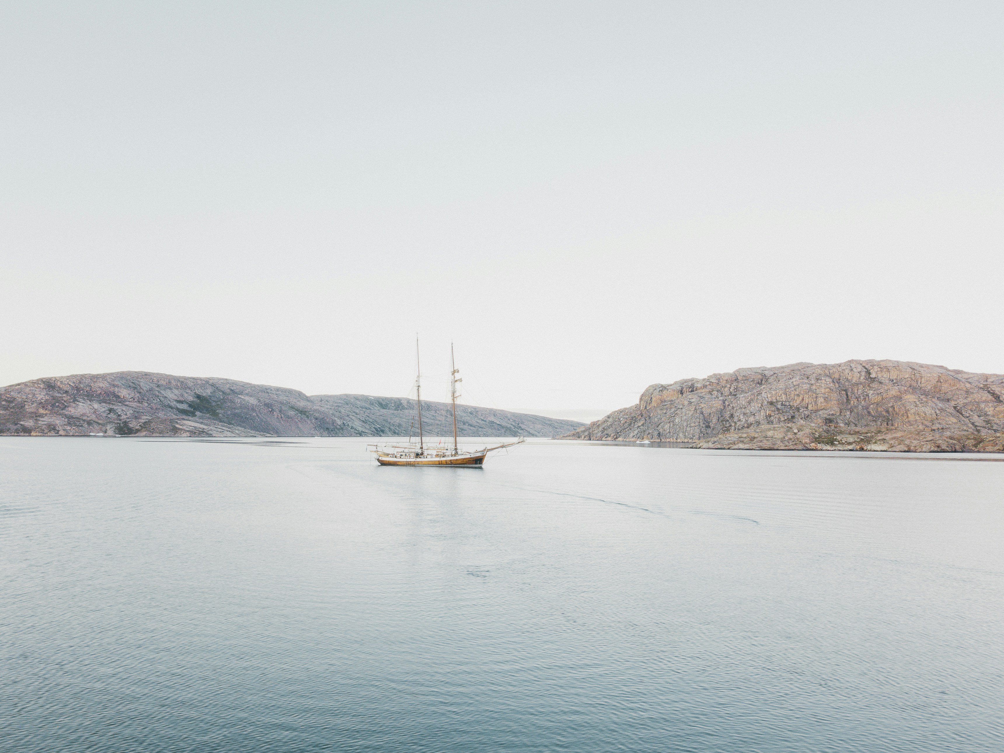 a large boat floating on top of a large body of water, 