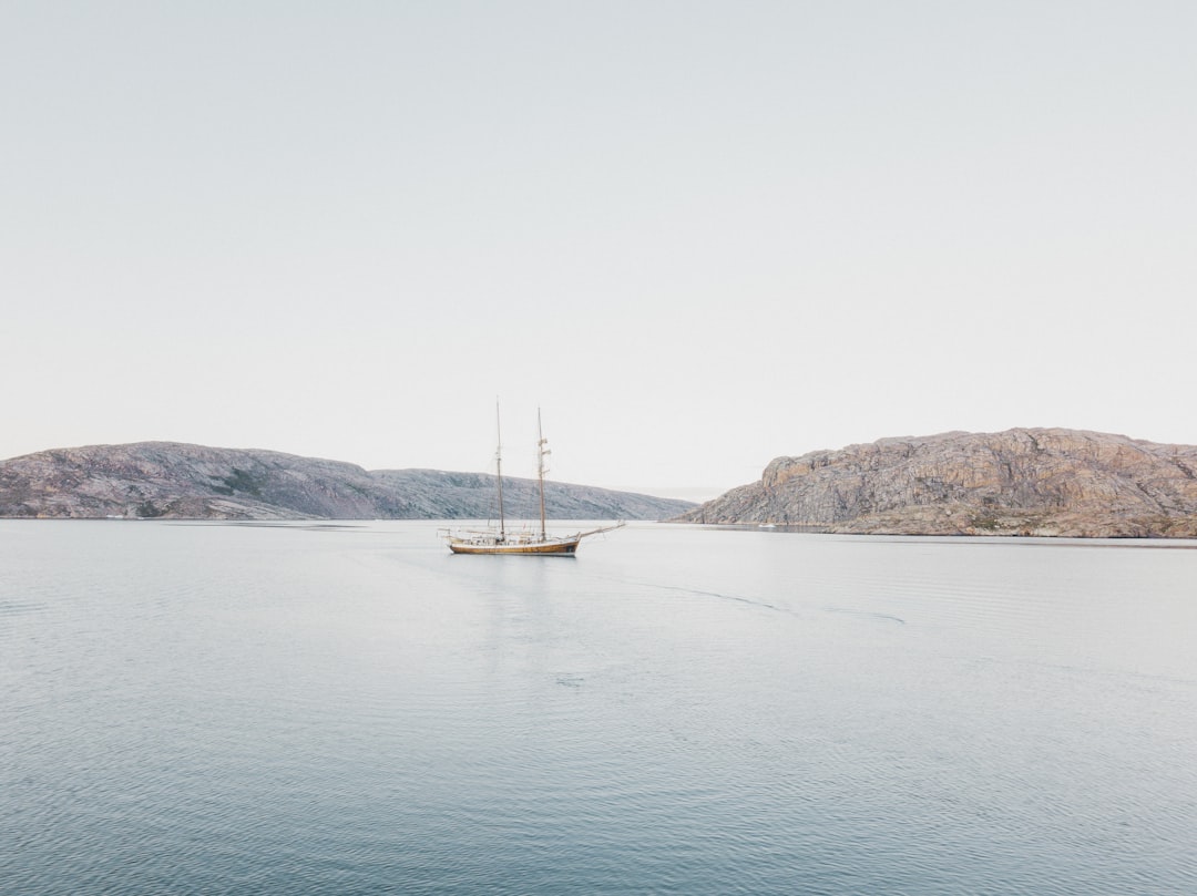 a large boat floating on top of a large body of water,