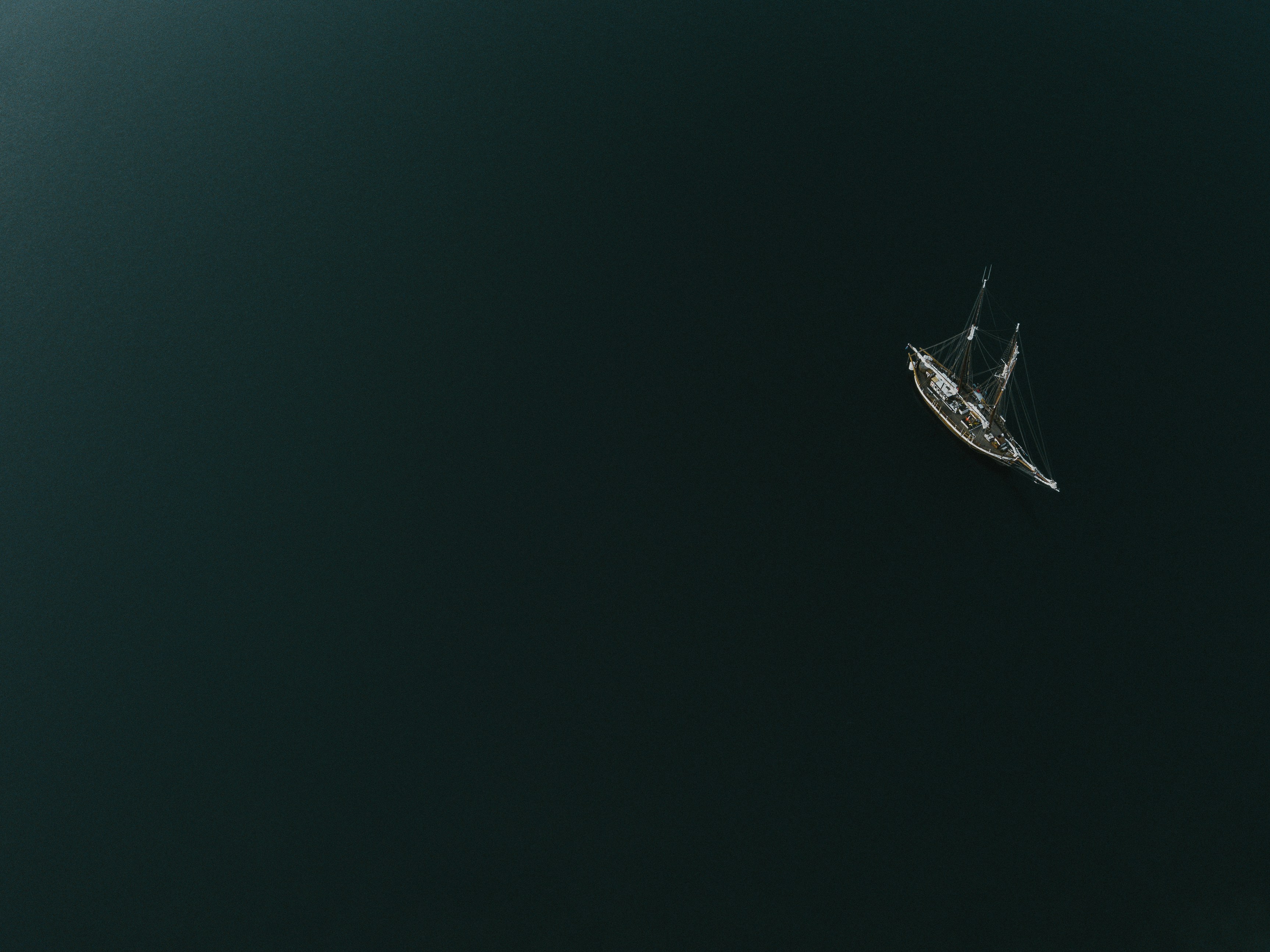 a small boat floating on top of a large body of water