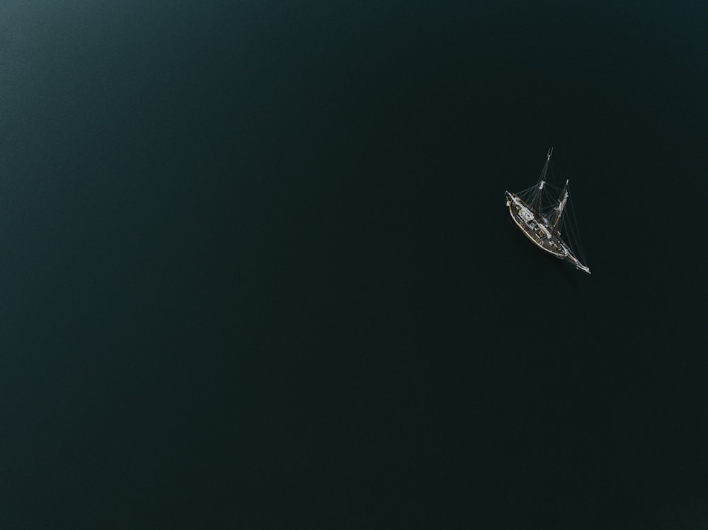 a small boat floating on top of a large body of water