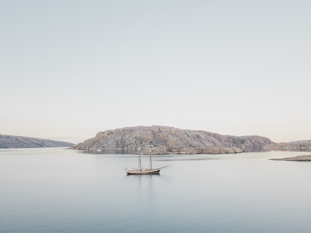 a boat floating on top of a large body of water